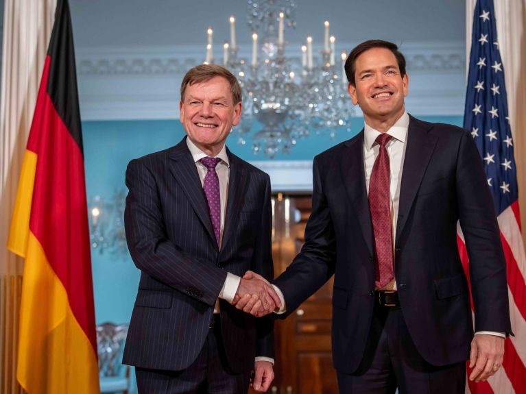 Johann Wadephul and US Secretary of State Marco Rubio shaking hands and smiling at the State Department